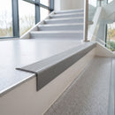 Silver self adhesive stair nosing fitted to a vinyl step edge in an office stairwell