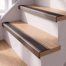 Champagne anodised self-adhesive 46x30mm stair nosing with black anti-slip rubber insert fitted to oak timber stairs in a home