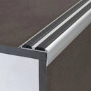 Close-up of silver anodised 36x20mm aluminium stair nosing with two black anti-slip rubber inserts on a step edge