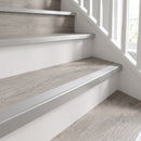 Silver anodised push-in LVT stair nosing 28x14.5mm fitted on grey oak vinyl stair treads with white risers