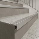 Aluminium LED stair nosing fitted to the edge of grey tiled steps with terrazzo treads