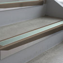Dark Bronze deep-riser square-edge aluminium stair nosing fitted along two bare concrete steps, 62mm tread plate and 56mm front face, with a Sage Green anti-slip insert running the full width of each step