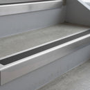 Mill Finish deep-riser square-edge aluminium stair nosing fitted along two bare concrete steps, 62mm tread plate and 56mm front face, with a Dark Grey anti-slip insert running the full width of each step