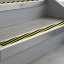 Mill Finish deep-riser square-edge aluminium stair nosing fitted along two bare concrete steps, 62mm tread plate and 56mm front face, with a Hazard anti-slip insert running the full width of each step