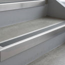 Mill Finish deep-riser square-edge aluminium stair nosing fitted along two bare concrete steps, 62mm tread plate and 56mm front face, with a Mid Grey anti-slip insert running the full width of each step