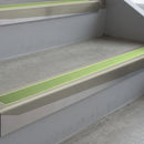 Mirroflect Silver deep-riser square-edge aluminium stair nosing fitted along two bare concrete steps, 62mm tread plate and 56mm front face, with a Apple Green anti-slip insert running the full width of each step
