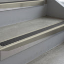 Mirroflect Silver deep-riser square-edge aluminium stair nosing fitted along two bare concrete steps, 62mm tread plate and 56mm front face, with a Dark Grey anti-slip insert running the full width of each step