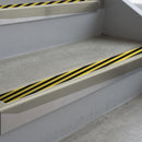 Mirroflect Silver deep-riser square-edge aluminium stair nosing fitted along two bare concrete steps, 62mm tread plate and 56mm front face, with a Hazard anti-slip insert running the full width of each step