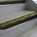Satin Black deep-riser square-edge aluminium stair nosing fitted along two bare concrete steps, 62mm tread plate and 56mm front face, with a Hazard anti-slip insert running the full width of each step