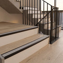 Satin black aluminium stair nosings with everest inserts on oak effect treads in an apartment building communal staircase