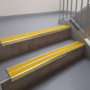 Square edge with ramped back aluminium stair nosing, 93mm tread, twin brimstone (safety yellow) exterior grip inserts, satin gold finish