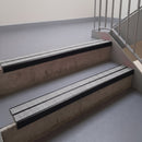 Square edge with ramped back aluminium stair nosing, 93mm tread, twin everest (light grey) exterior grip inserts, satin black finish