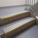 Square edge with ramped back aluminium stair nosing, 93mm tread, twin everest (light grey) exterior grip inserts, satin gold finish