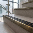 Antique Brass finish - solid brass ramped stair nosing 83x40mm with black carborundum grit inserts fitted on concrete steps