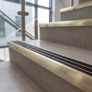 Satin Brushed finish - solid brass ramped stair nosing 83x40mm with black carborundum grit inserts fitted on concrete steps