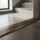 Solid Brass Stair Nosing 30mm Tread Ramp Feather Edge Profile in antique brass finish fitted on a step edge