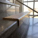Solid Brass Stair Nosing 59.5mm Raked Back Slimline Profile in antique brass finish fitted on a step edge