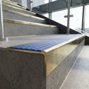Solid Brass Stair Nosing 59.5mm Raked Back Slimline Profile in polished brass finish fitted on a step edge