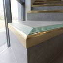Solid Brass Stair Nosing 59.5mm Raked Back Slimline Profile in satin brass finish fitted on a step edge