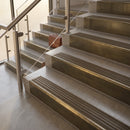 Antique Brass finish with Antique Brass insert - 59.5mm solid brass raked front single channel stair nosing fitted to a stone step