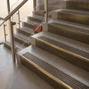 Antique Brass finish with Antique Bronze insert - 59.5mm solid brass raked front single channel stair nosing fitted to a stone step