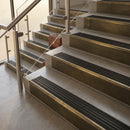 Antique Brass finish with Black Castellated insert - 59.5mm solid brass raked front single channel stair nosing fitted to a stone step