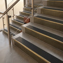 Antique Brass finish with Black Smooth Textured insert - 59.5mm solid brass raked front single channel stair nosing fitted to a stone step