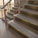 Antique Brass finish with Flint Castellated insert - 59.5mm solid brass raked front single channel stair nosing fitted to a stone step