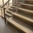 Antique Brass finish with Ivory Castellated insert - 59.5mm solid brass raked front single channel stair nosing fitted to a stone step