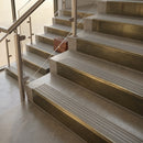 Antique Brass finish with Light Grey Castellated insert - 59.5mm solid brass raked front single channel stair nosing fitted to a stone step