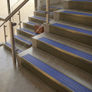 Antique Brass finish with Mid Blue Castellated insert - 59.5mm solid brass raked front single channel stair nosing fitted to a stone step