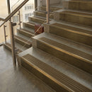 Antique Brass finish with Olive Castellated insert - 59.5mm solid brass raked front single channel stair nosing fitted to a stone step