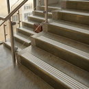 Antique Brass finish with Polar Grey Castellated insert - 59.5mm solid brass raked front single channel stair nosing fitted to a stone step