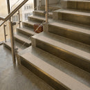 Antique Brass finish with Porth Stone Smooth Textured insert - 59.5mm solid brass raked front single channel stair nosing fitted to a stone step