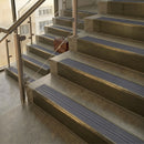 Antique Brass finish with Regency Castellated insert - 59.5mm solid brass raked front single channel stair nosing fitted to a stone step