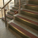 Antique Brass finish with Rustic Castellated insert - 59.5mm solid brass raked front single channel stair nosing fitted to a stone step