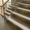 Antique Brass finish with White Castellated insert - 59.5mm solid brass raked front single channel stair nosing fitted to a stone step