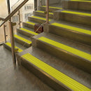 Antique Brass finish with Yellow Castellated insert - 59.5mm solid brass raked front single channel stair nosing fitted to a stone step