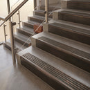 Antique Bronze finish with Antique Bronze insert - 59.5mm solid brass raked front single channel stair nosing fitted to a stone step