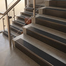 Antique Bronze finish with Black Smooth Textured insert - 59.5mm solid brass raked front single channel stair nosing fitted to a stone step