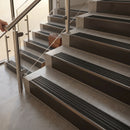 Antique Bronze finish with Black Castellated insert - 59.5mm solid brass raked front single channel stair nosing fitted to a stone step