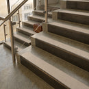 Antique Bronze finish with Porth Stone Smooth Textured insert - 59.5mm solid brass raked front single channel stair nosing fitted to a stone step