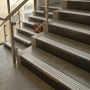 Antique Bronze finish with Polar Grey Castellated insert - 59.5mm solid brass raked front single channel stair nosing fitted to a stone step
