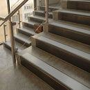 Antique Bronze finish with Polar Grey Smooth Textured insert - 59.5mm solid brass raked front single channel stair nosing fitted to a stone step