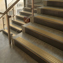 Antique Bronze finish with Satin Brass insert - 59.5mm solid brass raked front single channel stair nosing fitted to a stone step