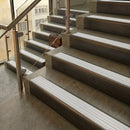Antique Bronze finish with White Castellated insert - 59.5mm solid brass raked front single channel stair nosing fitted to a stone step