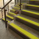 Antique Bronze finish with Yellow Castellated insert - 59.5mm solid brass raked front single channel stair nosing fitted to a stone step