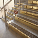 Polished Brass finish with Antique Brass insert - 59.5mm solid brass raked front single channel stair nosing fitted to a stone step