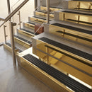 Polished Brass finish with Black Castellated insert - 59.5mm solid brass raked front single channel stair nosing fitted to a stone step