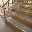 Polished Brass finish with Flint Castellated insert - 59.5mm solid brass raked front single channel stair nosing fitted to a stone step